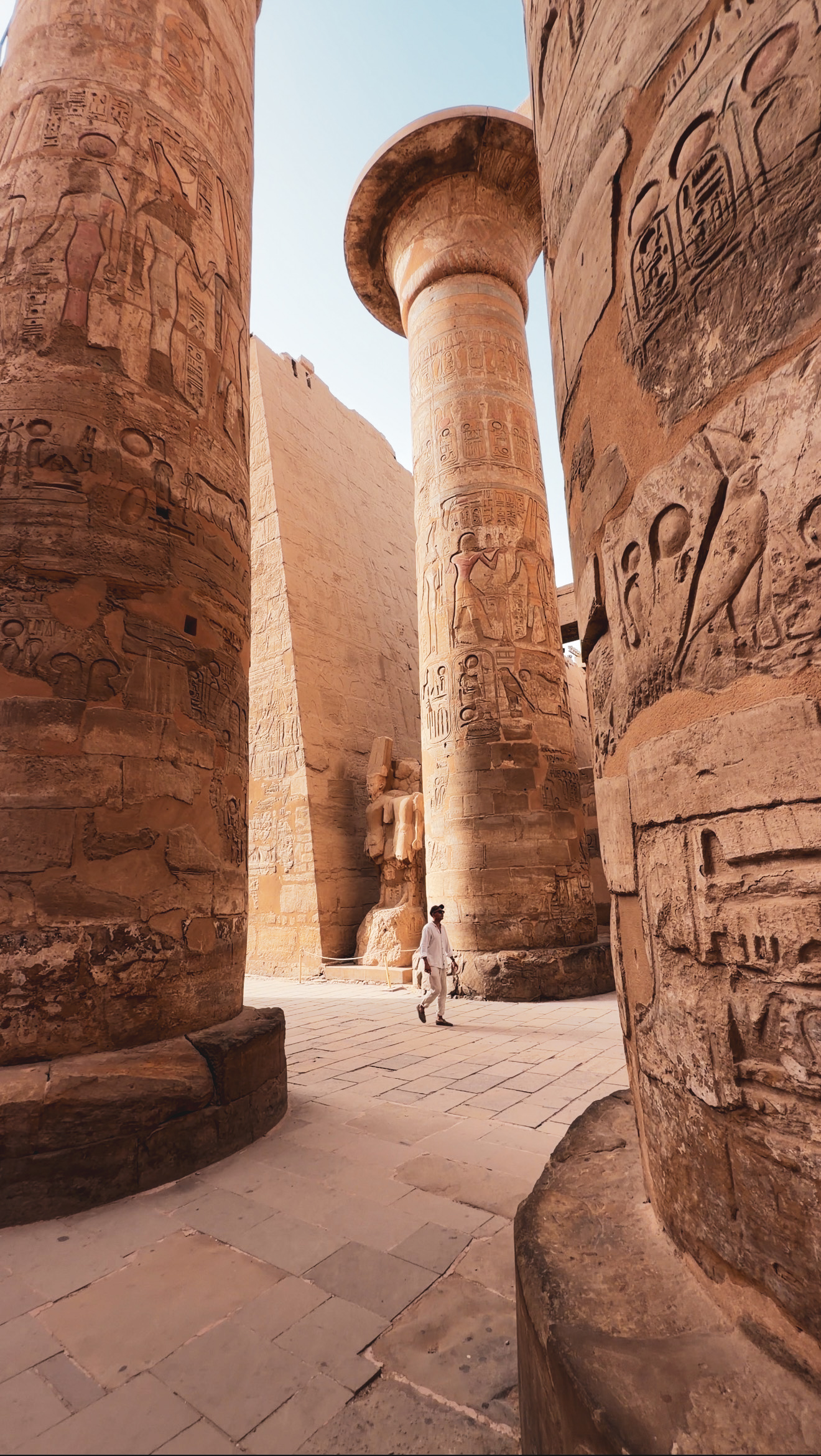 Private guide leading a client through an Egyptian temple, Egypt